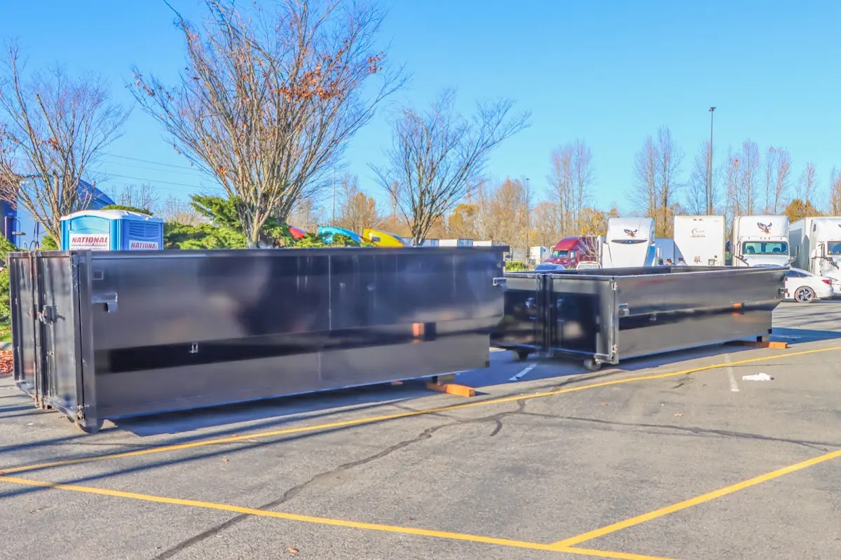 Professional dumpster rental service with roll-off container on residential driveway in Highlands Ranch